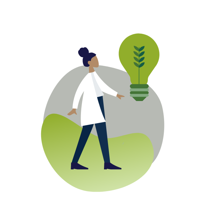 A person in a lab coat standing beside an energy efficient bulb